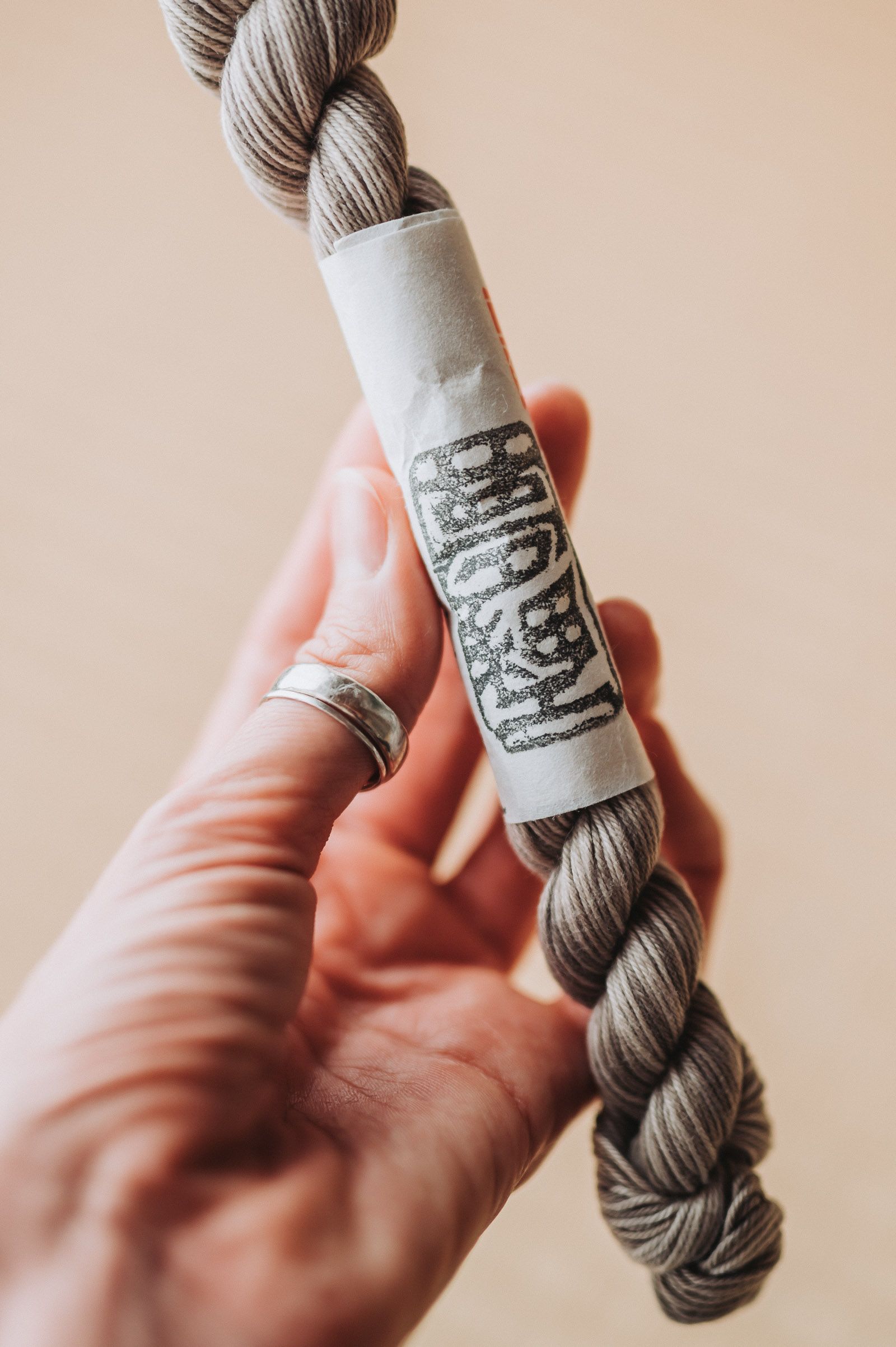 Natural dye variegated sashiko thread held in a hand.