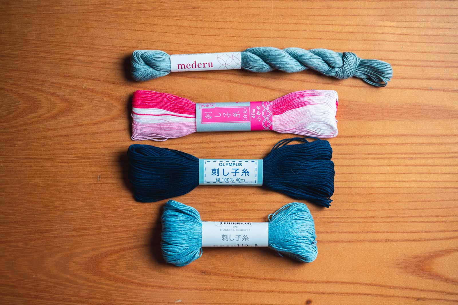 Four different brands of sashiko thread lined up.