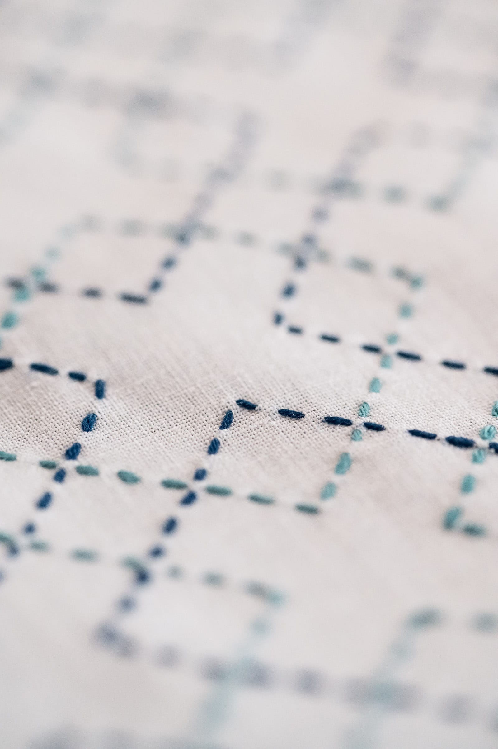 The sashiko pattern kasanemasusashi in two different shades of blue on white fabric