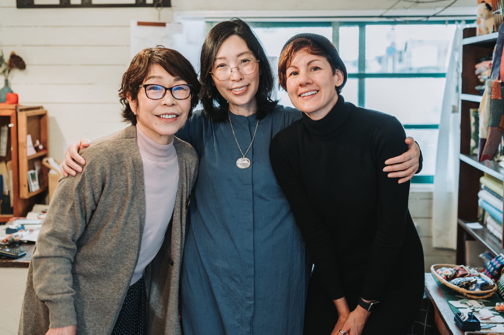 Three persons smiling at the camera at Oomae Nunoten in Hyuga