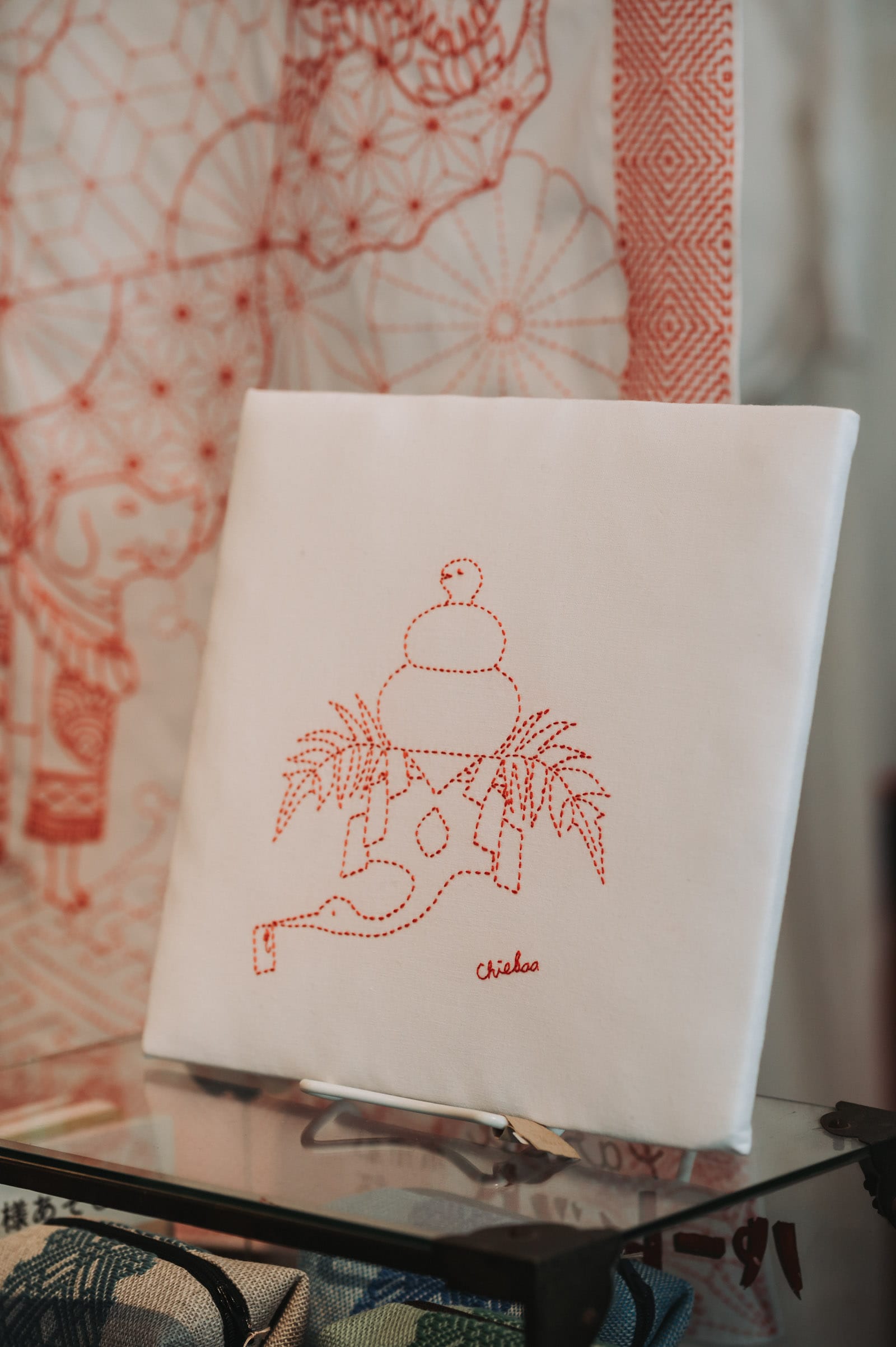 Sashiko that shows a crane with a snake doubling as a ricecake on top, serving as new year decoration taken at a 35 degree angle