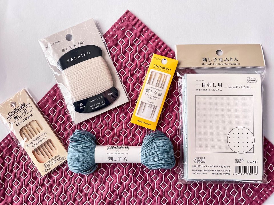 two packages sashiko needles, two different threads and one package of cloth by different brands