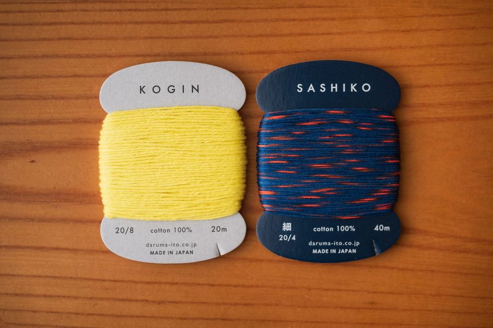 8 ply yellow kogin thread vs. 4 ply red and blue sashiko thread on cards by Daruma
