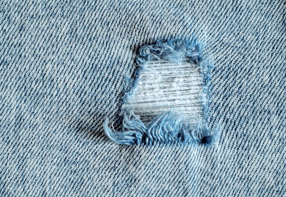 Denims with a hole close up.