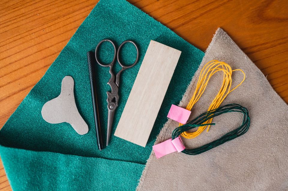 Tools needed to make a sashiko thimble: scissors, string, template, leather etc.